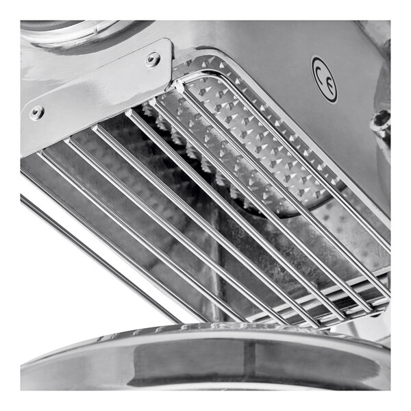 A close-up of the stainless steel Estella Electric Hard Cheese Grater plate.