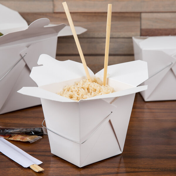 A white Fold-Pak Chinese take-out box with rice and chopsticks.