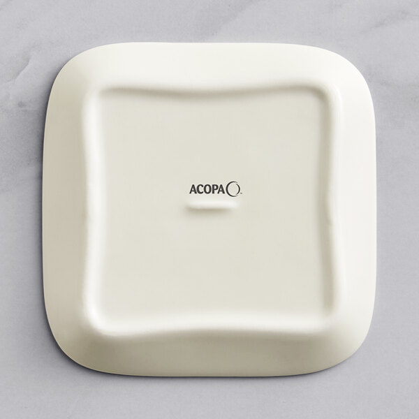 A white square Acopa porcelain butter dish with black text reading "Acopa" on the lid.