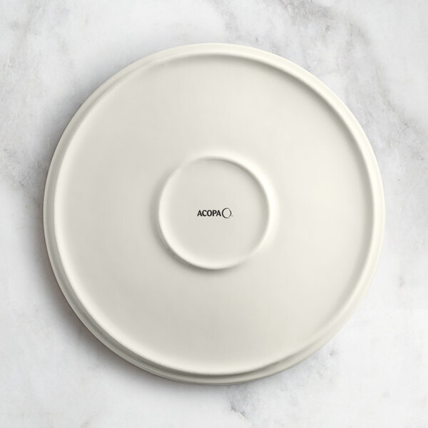 An Acopa Cape beige porcelain plate with black text that says "Oma" on it.