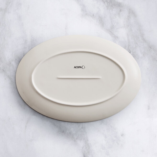 An Acopa beige porcelain oval platter on a white background.