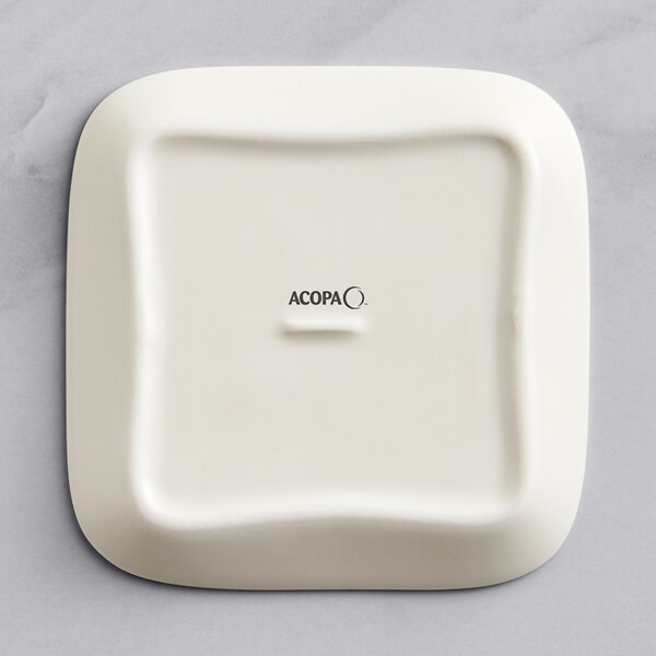 A white square Acopa Cape porcelain butter dish with black text reading "Butter" on the lid.