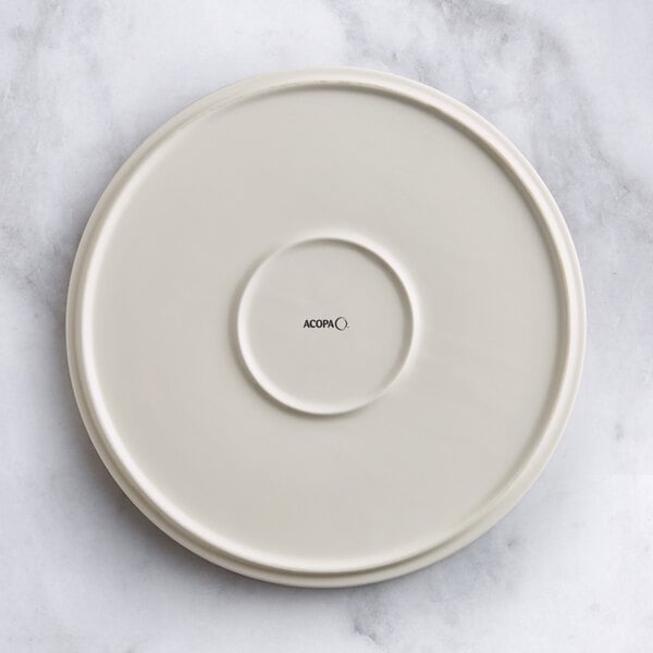 An Acopa Cape beige porcelain plate with a circular design on it.