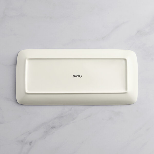 A rectangular beige porcelain platter on a white background.