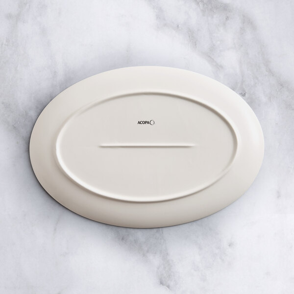 An Acopa Cape gray porcelain oval platter on a marble surface.
