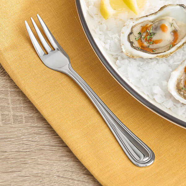 A plate of oysters with an Acopa Edgeworth stainless steel oyster fork.