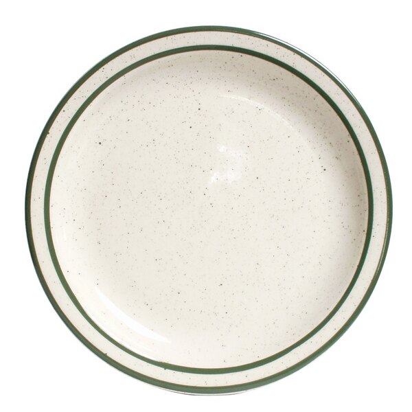 A close-up of a Tuxton white plate with green speckled rim.