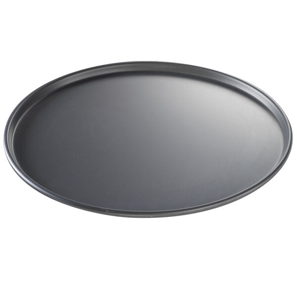 A black round Chicago Metallic pizza pan.