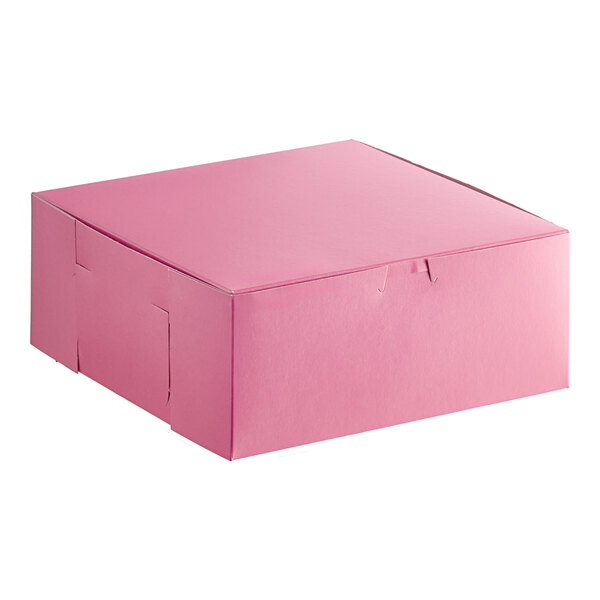 A pink square bakery box with a closed lid.
