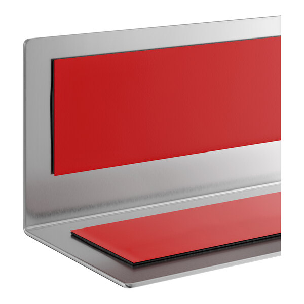A stainless steel wall corner guard with red protective strips.
