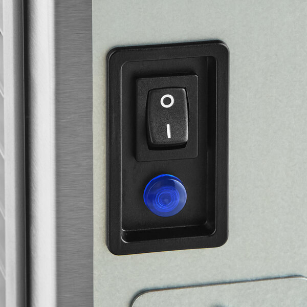A close-up of a power switch and indicator light on an Avantco Ice Diamond EMC-F-530-A modular ice machine.