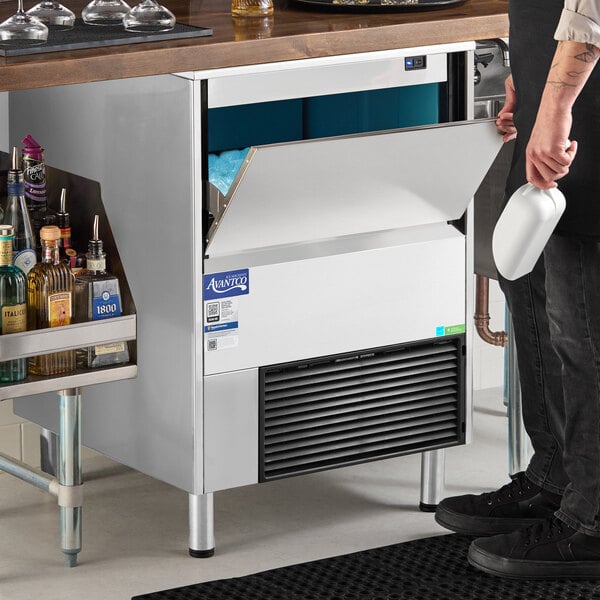 An undercounter air-cooled ice machine with a stainless steel exterior and a front-opening bin, designed for commercial use.