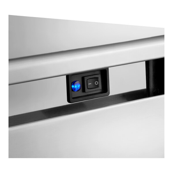 A close-up of the control switch panel on a stainless steel undercounter ice machine.