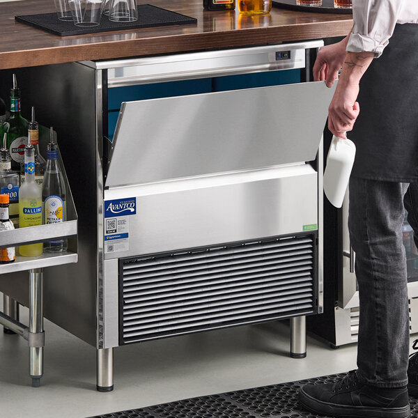An undercounter air-cooled ice machine with a stainless steel exterior and a front-opening bin.
