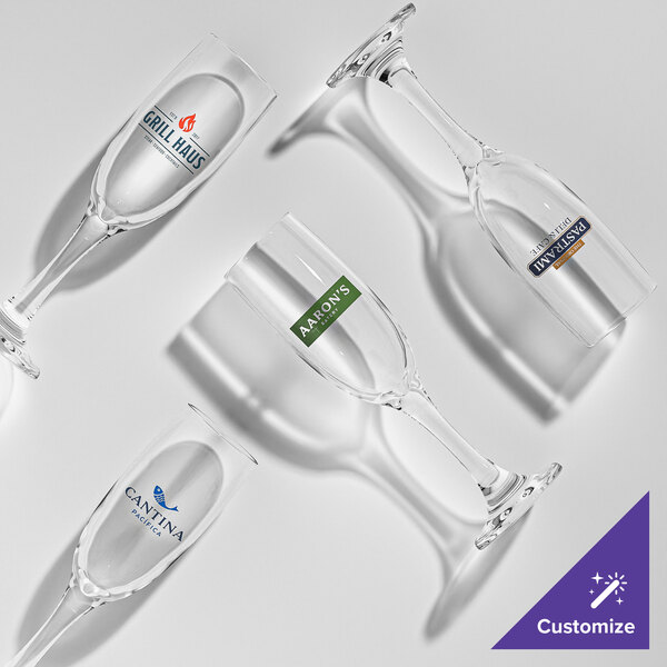 A set of clear 6 oz. flute glasses, each with a customizable logo or design.