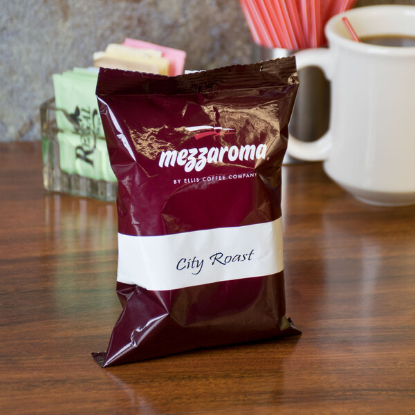 A case of Ellis Mezzaroma City Roast coffee packets on a table.