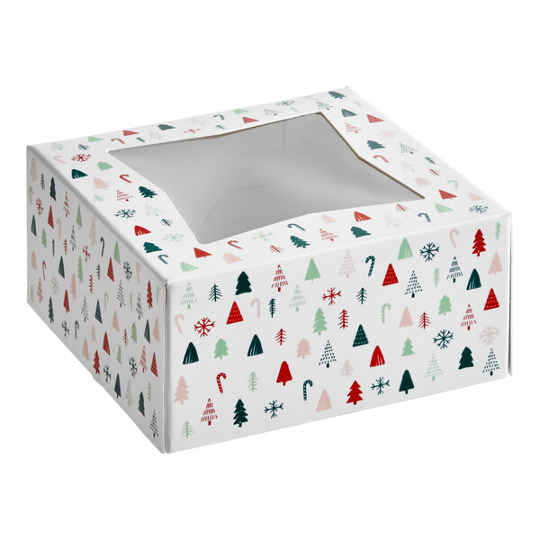 A square bakery box with a clear window on top and a modern Christmas print featuring trees, snowflakes, and candy canes.