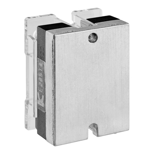 A rectangular metallic component with a brushed finish, featuring a hole and a notch on one side, attached to a transparent mounting bracket.
