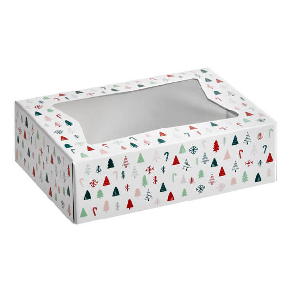 A rectangular bakery box with a clear window on top and a modern Christmas print featuring trees, candy canes, and snowflakes.
