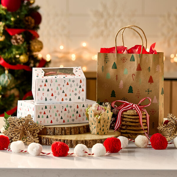 A stack of rectangular bakery boxes with a modern Christmas print and a clear window on top.