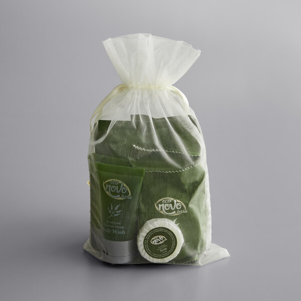 An 11-piece hotel amenity toiletries kit in a sheer drawstring bag, featuring Novo Terra Eucalyptus and Lemon Myrtle products.
