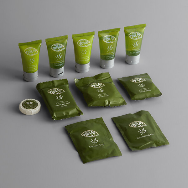 An 11-piece hotel amenity toiletries kit with green packaging, including tubes and packets of various personal care products.