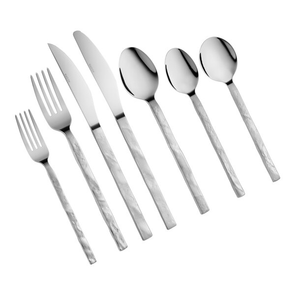 An assortment of stainless steel flatware including forks, knives, and spoons with textured handles.