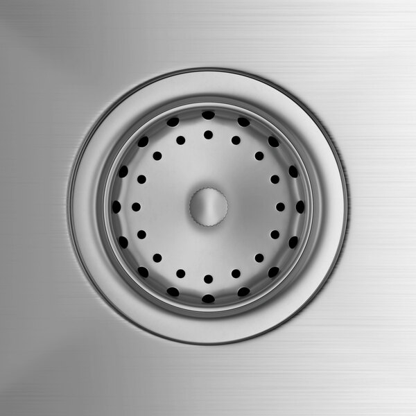 A stainless steel commercial sink drain with a perforated strainer basket.