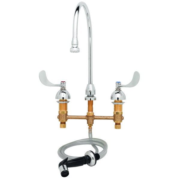 A chrome T&S deck-mount faucet with gooseneck and wrist action handles and sidespray hose.