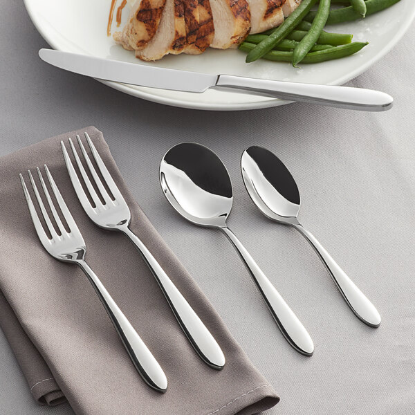 A five-piece set of stainless steel flatware including two forks, two spoons, and a knife.