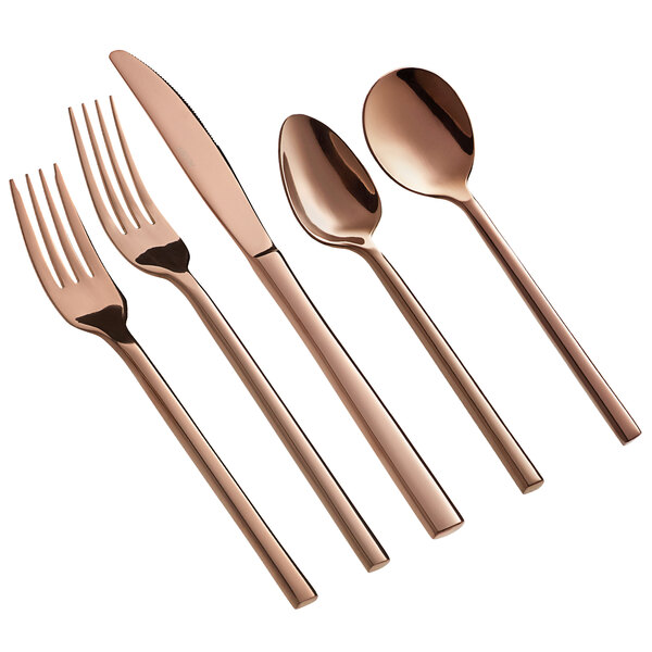 A five-piece set of rose gold stainless steel flatware including two forks, a knife, and two spoons.