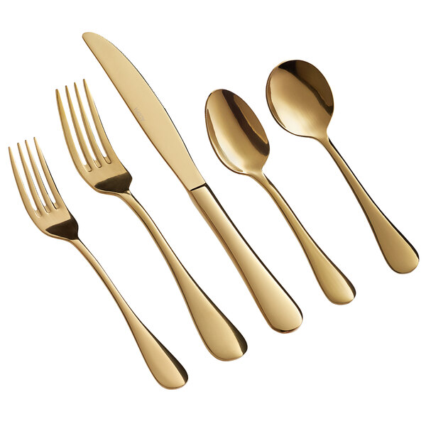 A five-piece set of gold-colored stainless steel flatware including two forks, a knife, and two spoons.
