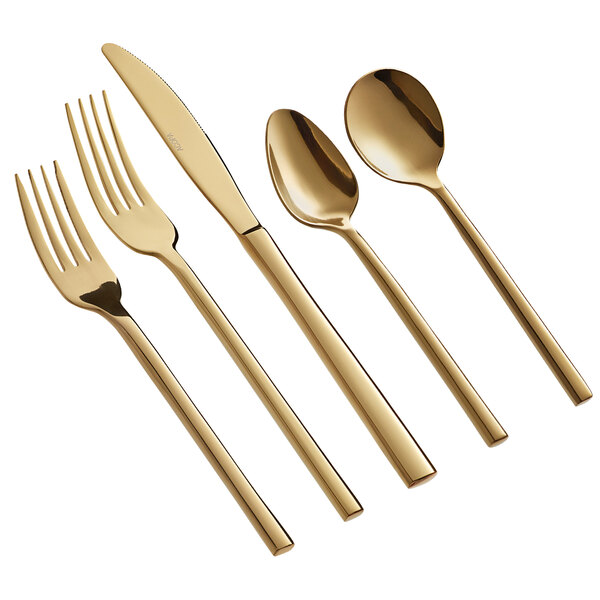 A five-piece set of gold-colored stainless steel flatware including two forks, a knife, and two spoons.