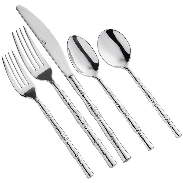 A five-piece set of stainless steel flatware with a decorative handle design.