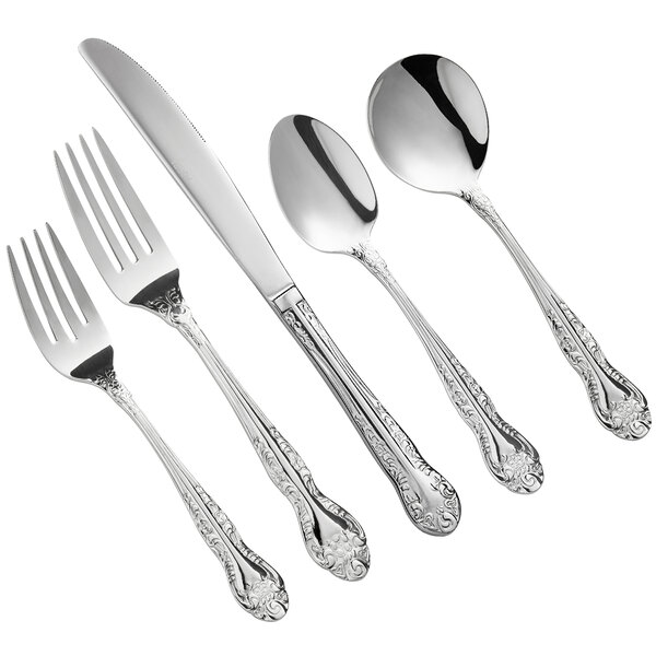 A five-piece set of stainless steel flatware with ornate handles, including two forks, a knife, and two spoons.