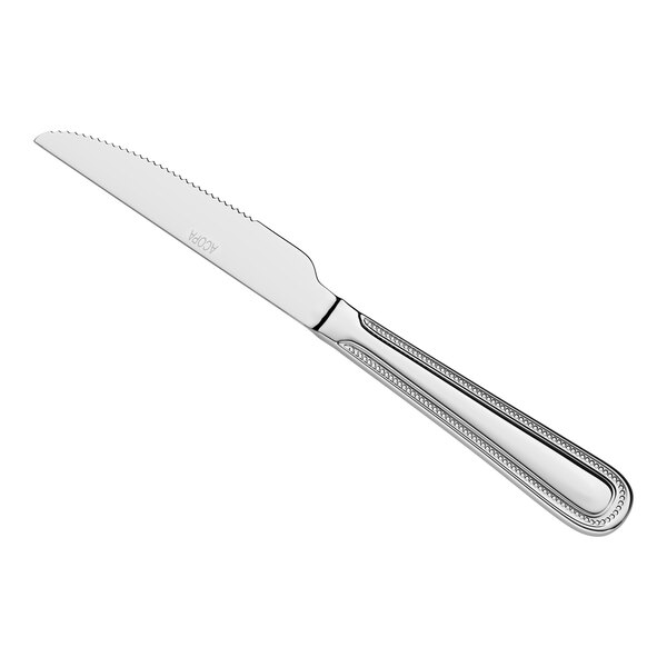 A stainless steel steak knife with a serrated edge and a decorative handle.
