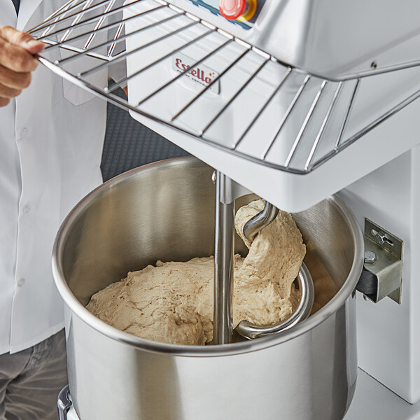 A metal safety guard attachment for a commercial dough mixer.