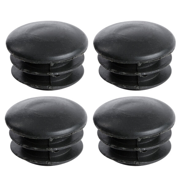 A close-up of 4 black plastic caps for shelving posts.