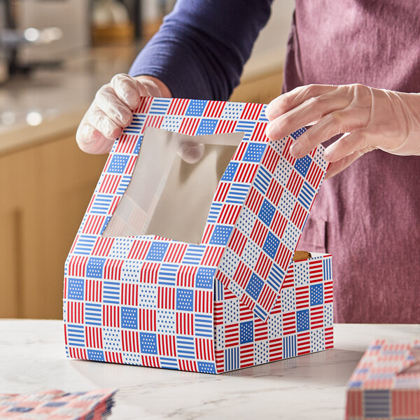 A patriotic USA print bakery box with a clear window and red, white, and blue flag pattern.