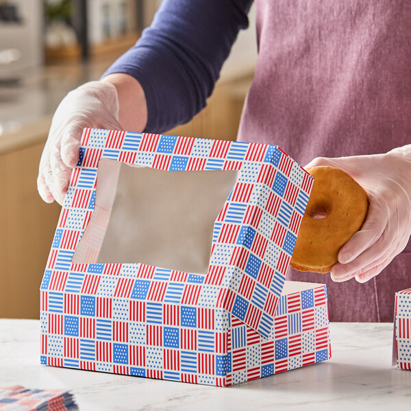A rectangular bakery box with a patriotic USA flag print and a clear window on top.