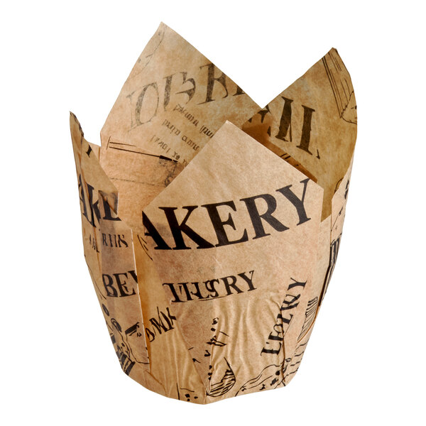 A brown tulip-shaped baking cup with a newspaper print design and the word 'BAKERY' prominently displayed.