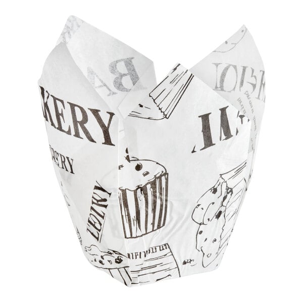 A white tulip-shaped baking cup with a newspaper print design.