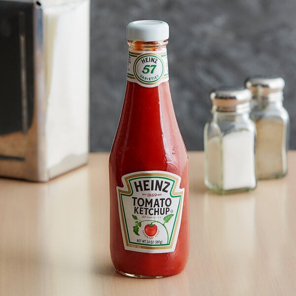 A case of 24 Heinz ketchup bottles on a table.