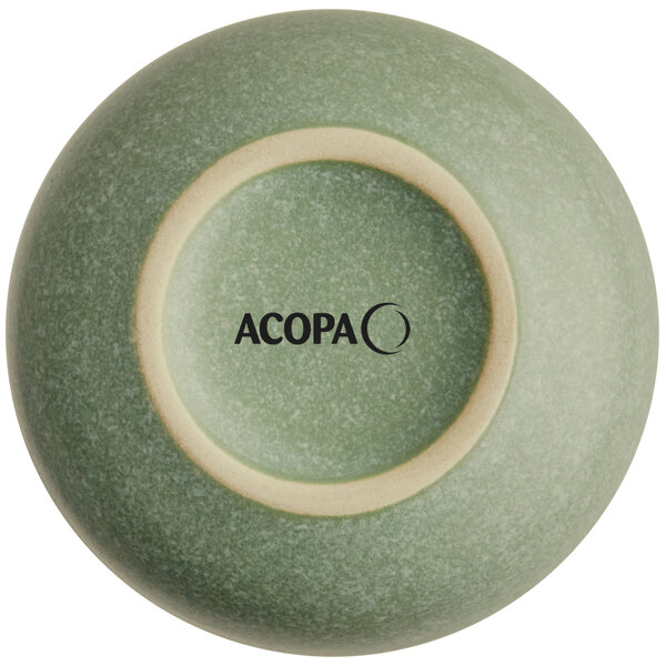 The image shows the bottom view of a small, round, sage green bowl with a matte finish and the brand name 'ACOPA' printed on the base.