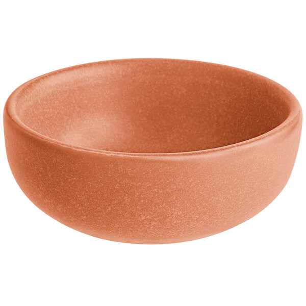 A small, round, terra cotta-colored bowl with a matte finish.