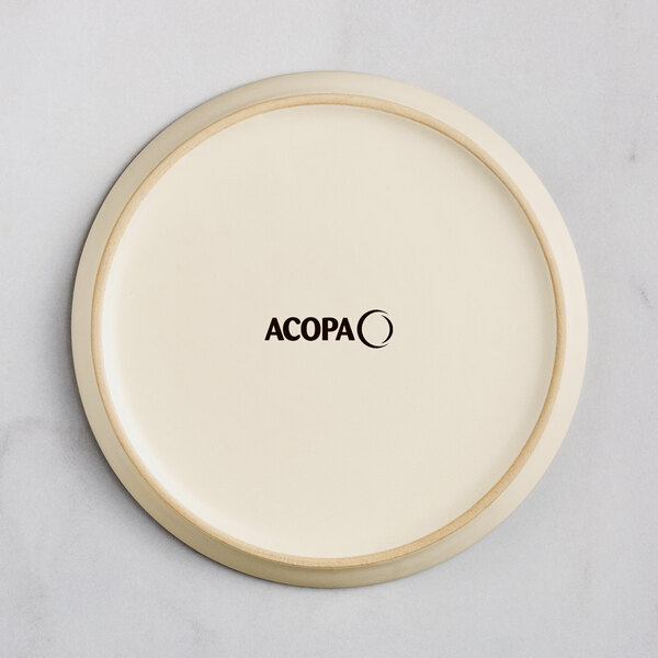 A round, off-white plate with a matte finish and the word 'ACOPA' printed in black at the center.