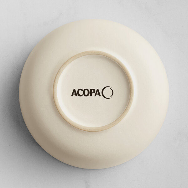The image shows the underside of a round, off-white bowl with the brand name 'ACOPA' printed in black on the base.
