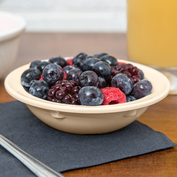 A tan GET SuperMel bowl filled with blueberries on a table.