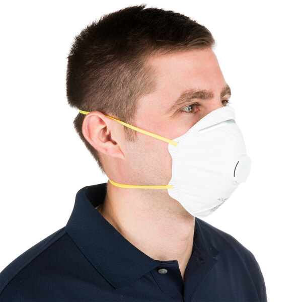 A man wearing a Cordova N-95 valved particulate respirator with yellow straps.