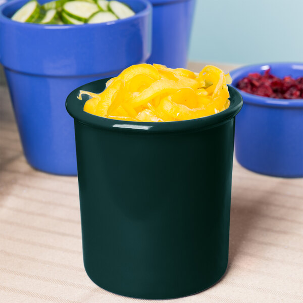 A hunter green Tablecraft condiment bowl filled with food.
